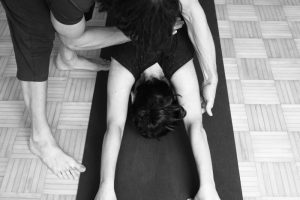 Grischa demonstrating an assist for Adho Mukha Shvanasana in Ashtanga Teacher Intensive